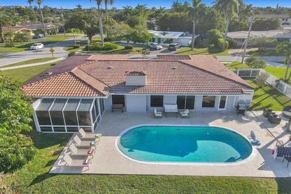 an aerial view of a house with a yard