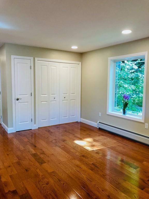 499 Jacksonville Road Colrain, MA 01340 - Photo 11 of 30 a view of an empty room with window a ceiling fan and wooden floor
