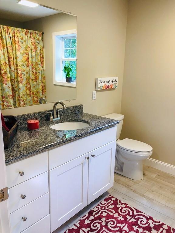 499 Jacksonville Road Colrain, MA 01340 - Photo 13 of 30 a bathroom with a granite countertop toilet sink and mirror