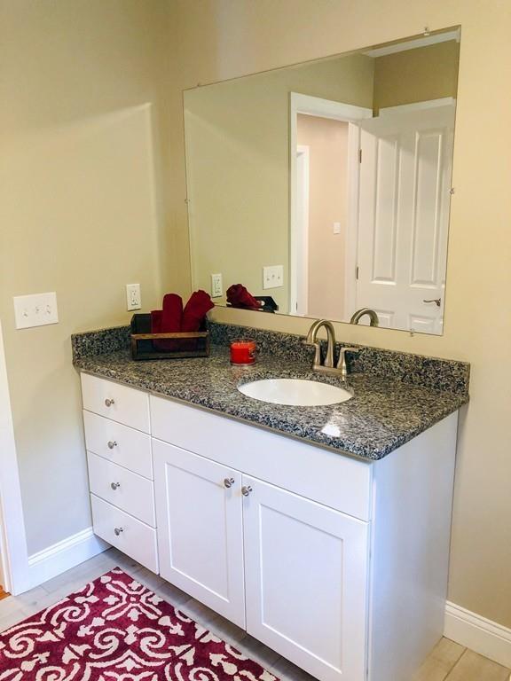 499 Jacksonville Road Colrain, MA 01340 - Photo 14 of 30 a bathroom with a granite countertop sink and a mirror