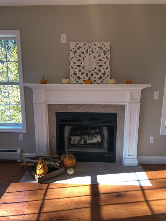 499 Jacksonville Road Colrain, MA 01340 - Photo 17 of 30 a fireplace with a vase on top of it
