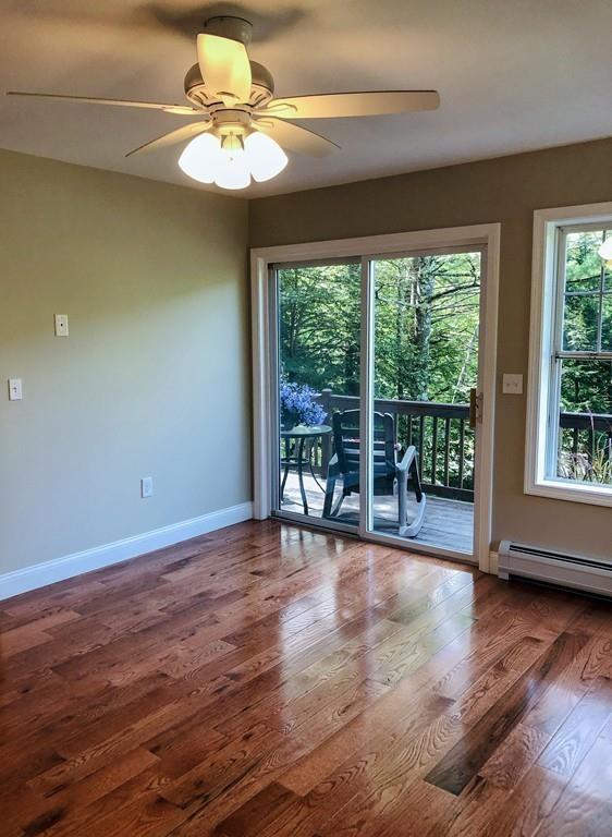 499 Jacksonville Road Colrain, MA 01340 - Photo 20 of 30 a view of an empty room with wooden floor and a window