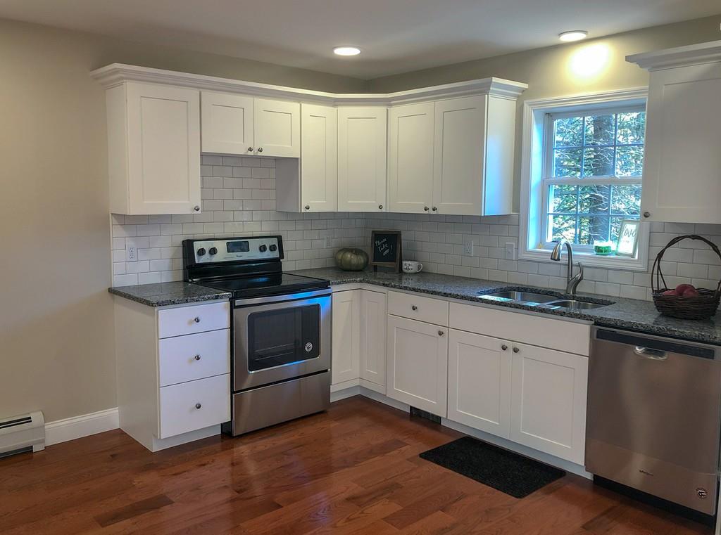 499 Jacksonville Road Colrain, MA 01340 - Photo 8 of 30 a kitchen with white cabinets sink and appliances