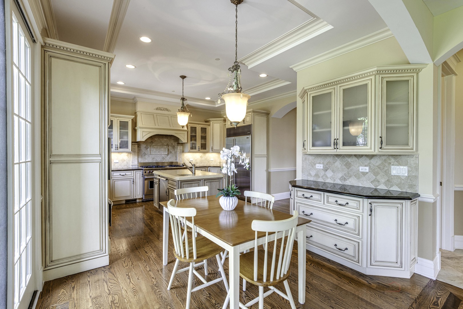 214 Linden Road Northbrook, IL 60062 - Photo 17 of 56 a kitchen with stainless steel appliances kitchen island granite countertop a stove a refrigerator a dining table and chairs with wooden floor