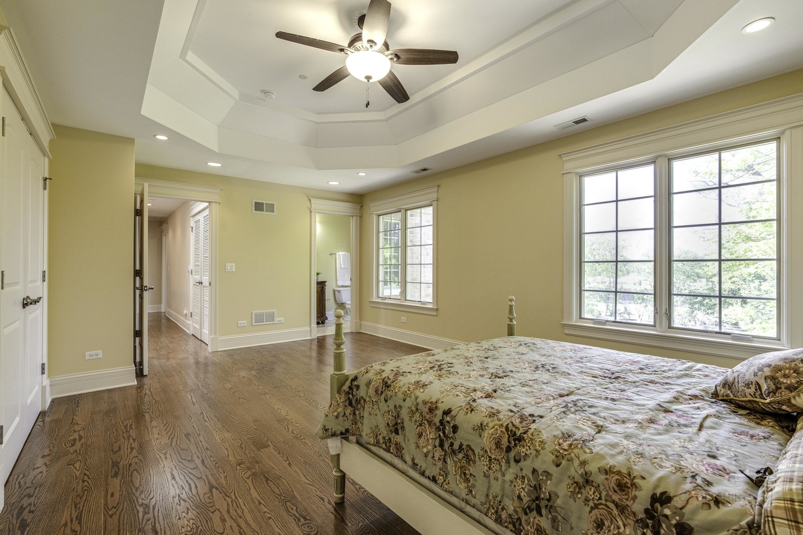 214 Linden Road Northbrook, IL 60062 - Photo 33 of 56 a spacious bedroom with a large bed and a chandelier