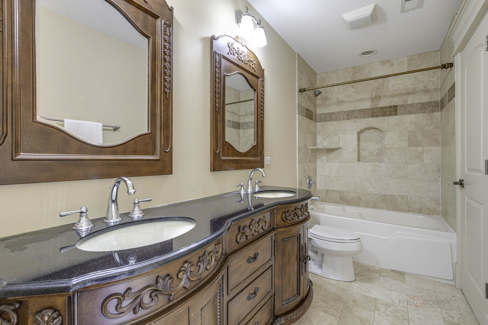 214 Linden Road Northbrook, IL 60062 - Photo 39 of 56 a bathroom with a granite countertop sink a toilet a mirror a vanity a bathtub and shower