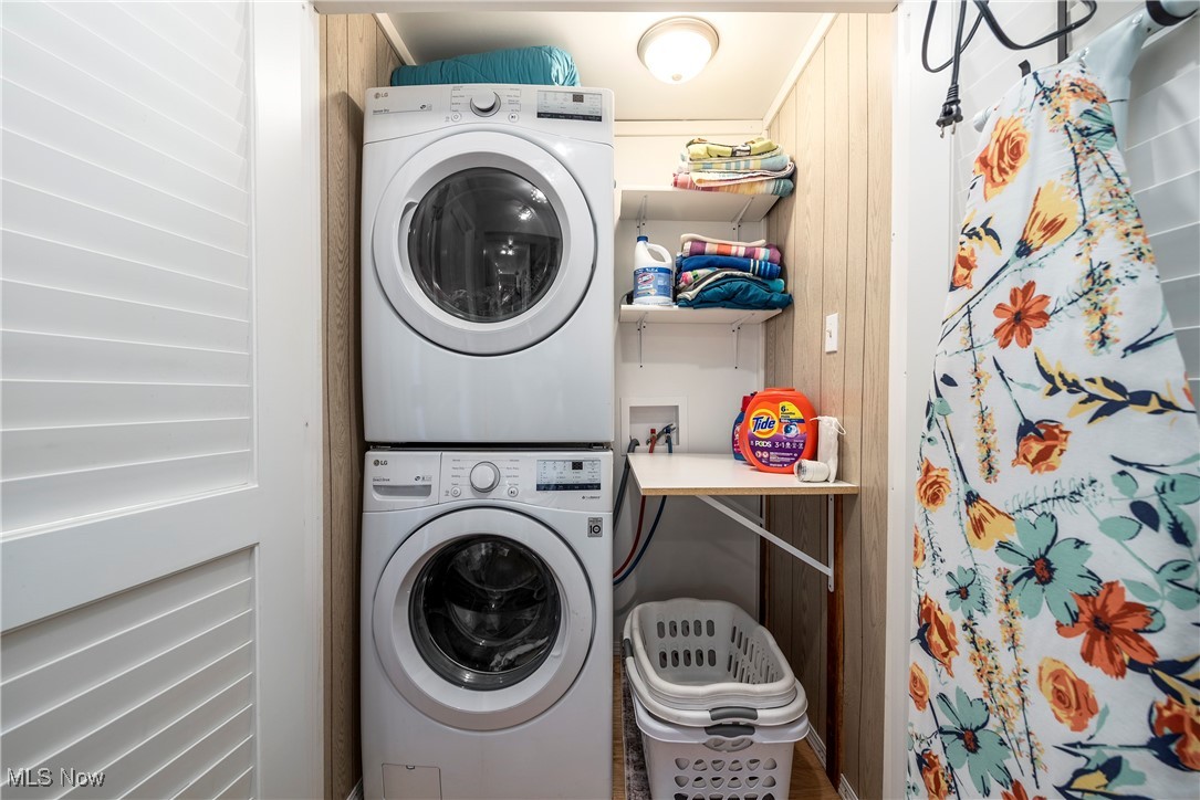 8767 Edgehill Road Mentor, OH 44060 - Photo 23 of 47 Laundry room featuring wooden walls and stacked washer and clothes dryer