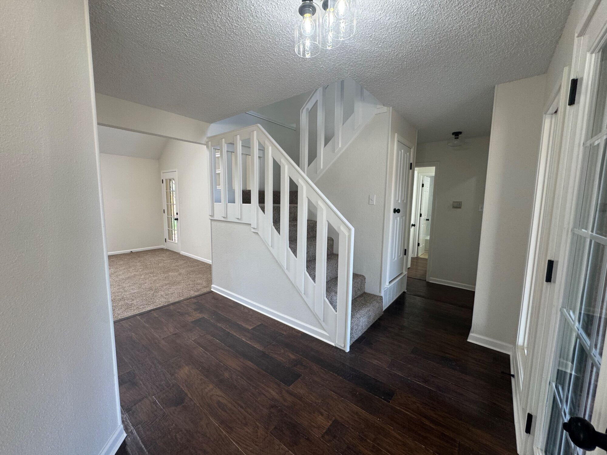 5510 87th Street Lubbock, TX 79424 - Photo 6 of 13 a view of a hallway with wooden floor and staircase