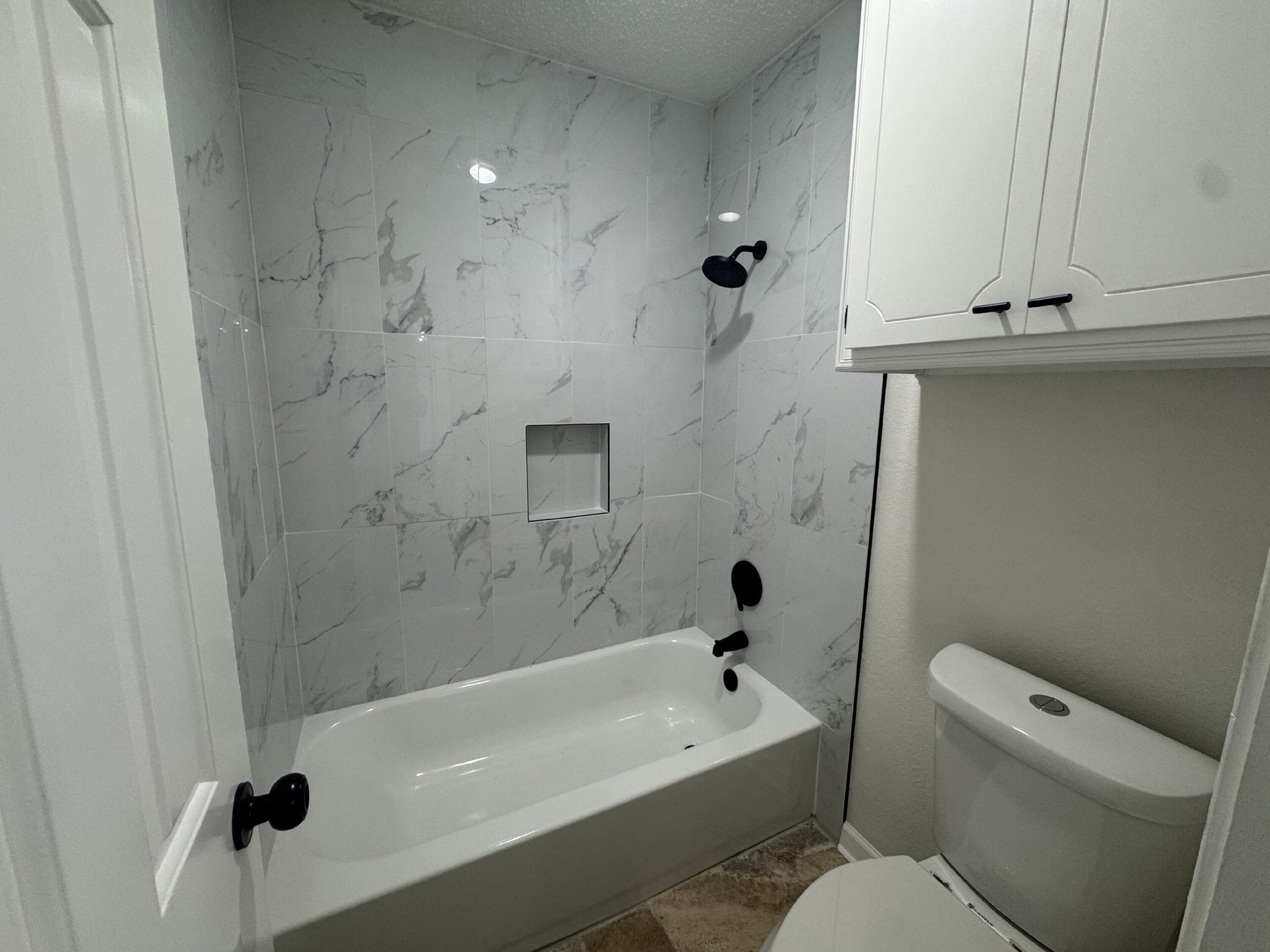 5510 87th Street Lubbock, TX 79424 - Photo 9 of 13 a bathroom with a sink a toilet and shower