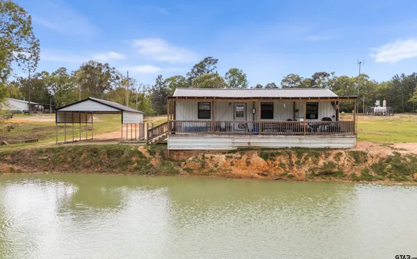 a view of a house with swimming pool and a yard