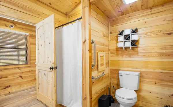 a bathroom with a toilet and a shower