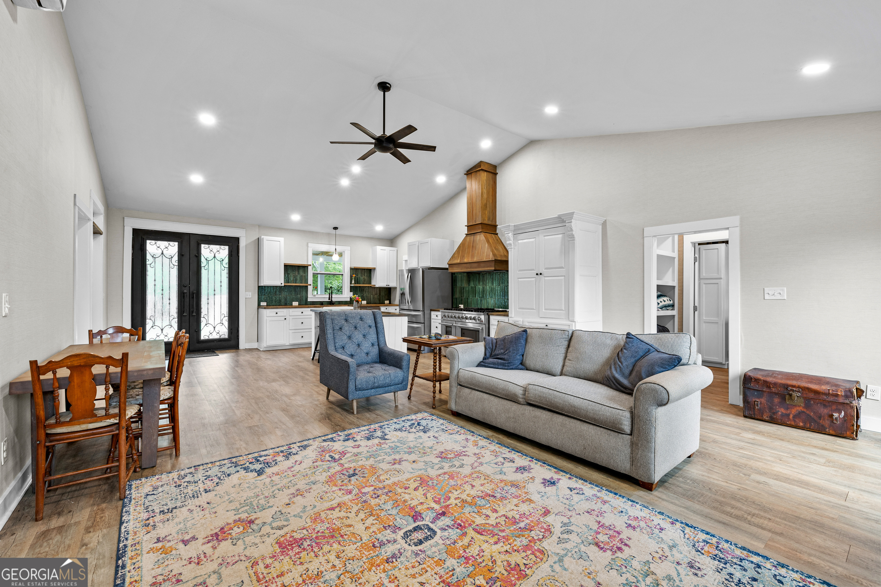 1329 Standing Rock Road Senoia, GA 30276 - Photo 30 of 77 a living room with furniture kitchen view and a chandelier