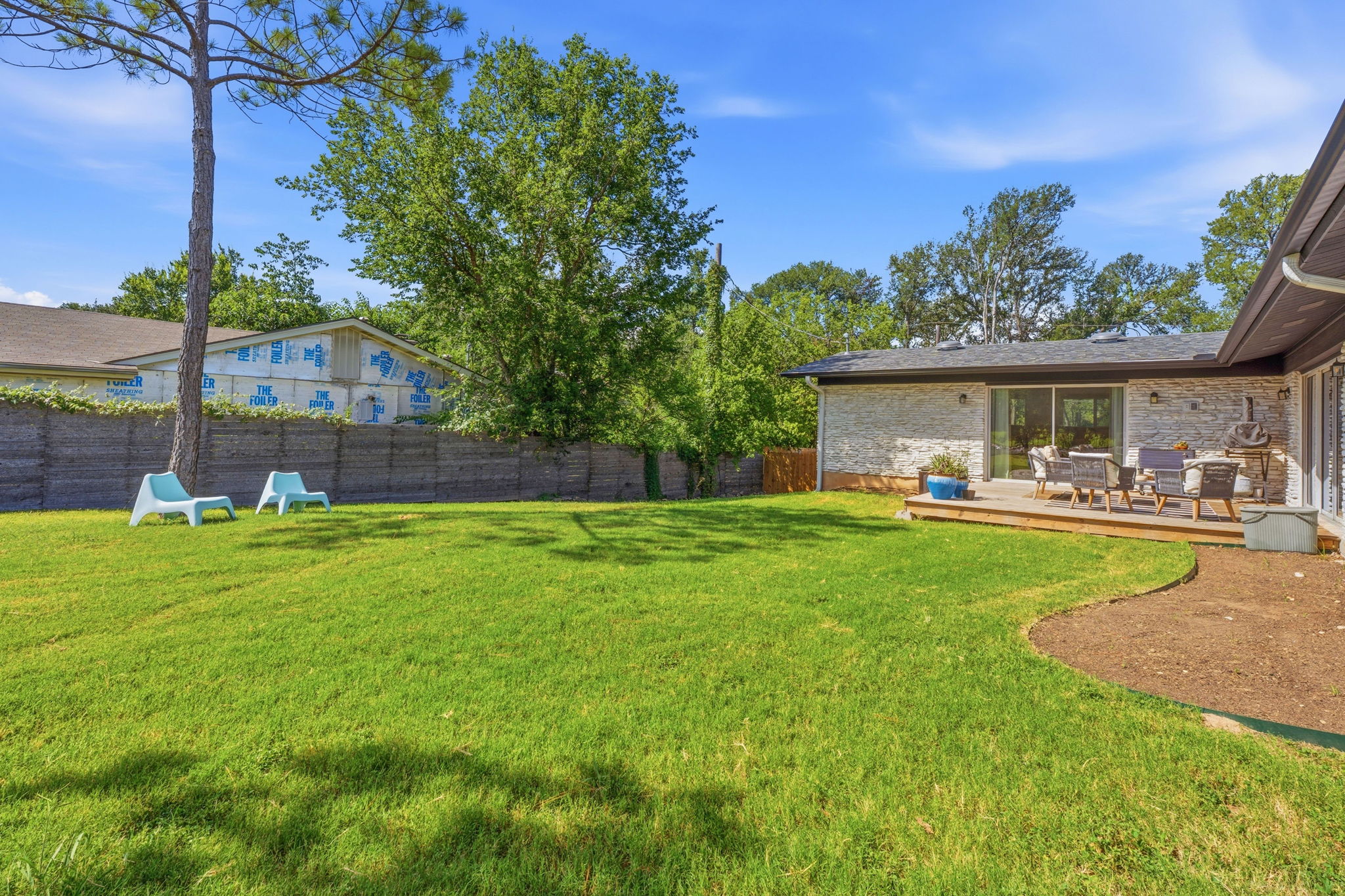 4403 Elmsgrove Drive Austin, TX 78721 - Photo 16 of 38 A spacious backyard with a private deck creates an ideal setting for outdoor gatherings.