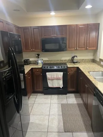 a kitchen with wooden cabinets a sink and a stove