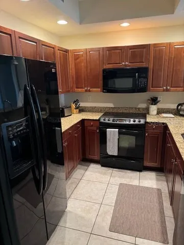 a kitchen with a stove a refrigerator and a sink