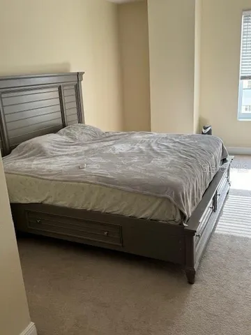 a bedroom with a bed and window