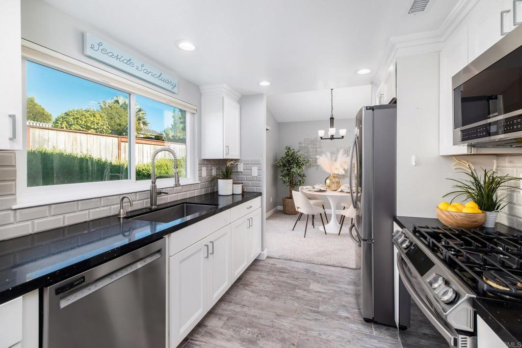 2725 Glasgow Drive Carlsbad, CA 92010 - Photo 13 of 41 a kitchen with stainless steel appliances granite countertop a stove a sink and a microwave