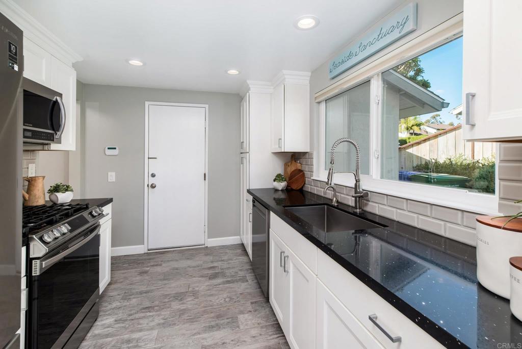 2725 Glasgow Drive Carlsbad, CA 92010 - Photo 15 of 41 a kitchen with granite countertop stainless steel appliances a sink stove top oven and cabinets