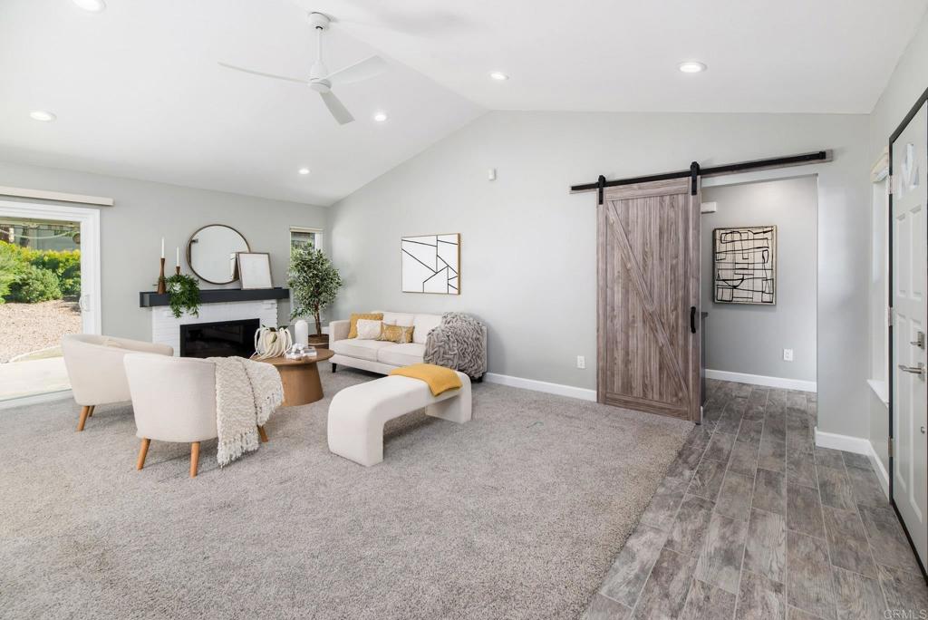2725 Glasgow Drive Carlsbad, CA 92010 - Photo 16 of 41 a living room with furniture a fireplace and a chandelier