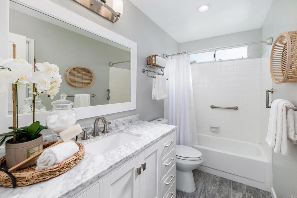 2725 Glasgow Drive Carlsbad, CA 92010 - Photo 21 of 41 a bathroom with a granite countertop sink toilet shower and a mirror