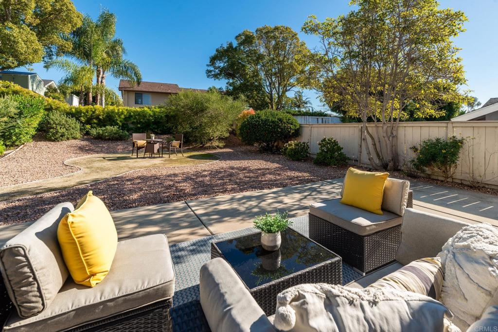 2725 Glasgow Drive Carlsbad, CA 92010 - Photo 32 of 41 a view of a backyard with couches table and chairs with wooden fence