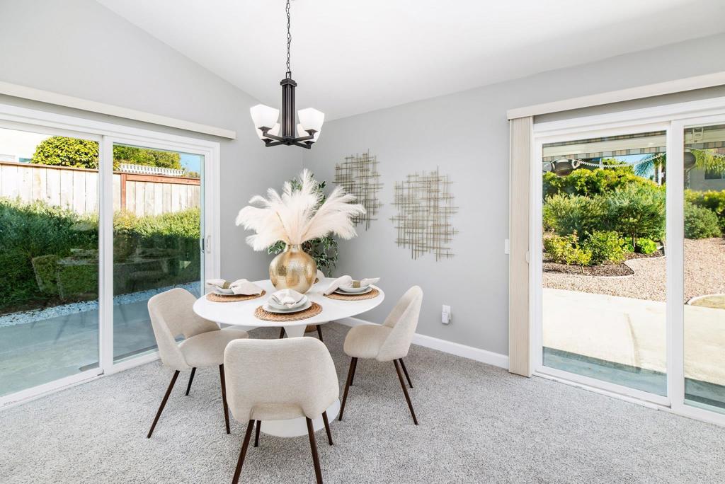 2725 Glasgow Drive Carlsbad, CA 92010 - Photo 10 of 41 a dining room with furniture a large window and a chandelier