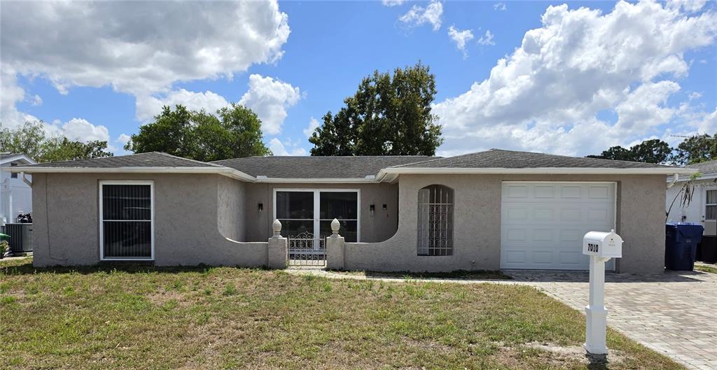 7010 Potomac Drive Port Richey, FL 34668 - Photo 1 of 1 a front view of a house with garden