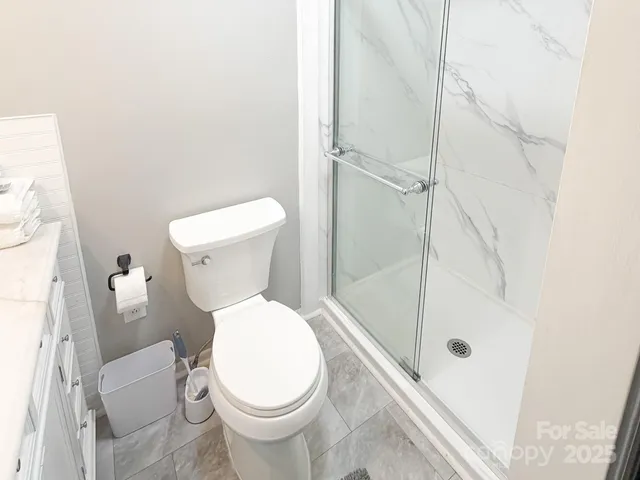 a white toilet sitting next to a bath tub