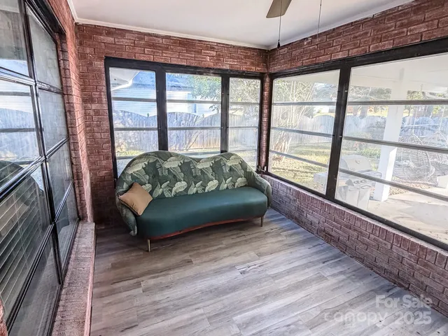 a bedroom with furniture and a large window