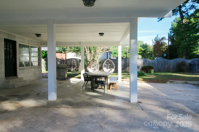 a view of a patio with a table chairs and a backyard