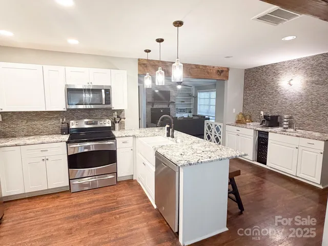 a kitchen with a sink stove and cabinets