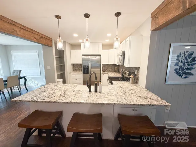 a view of dining table chairs and chandelier
