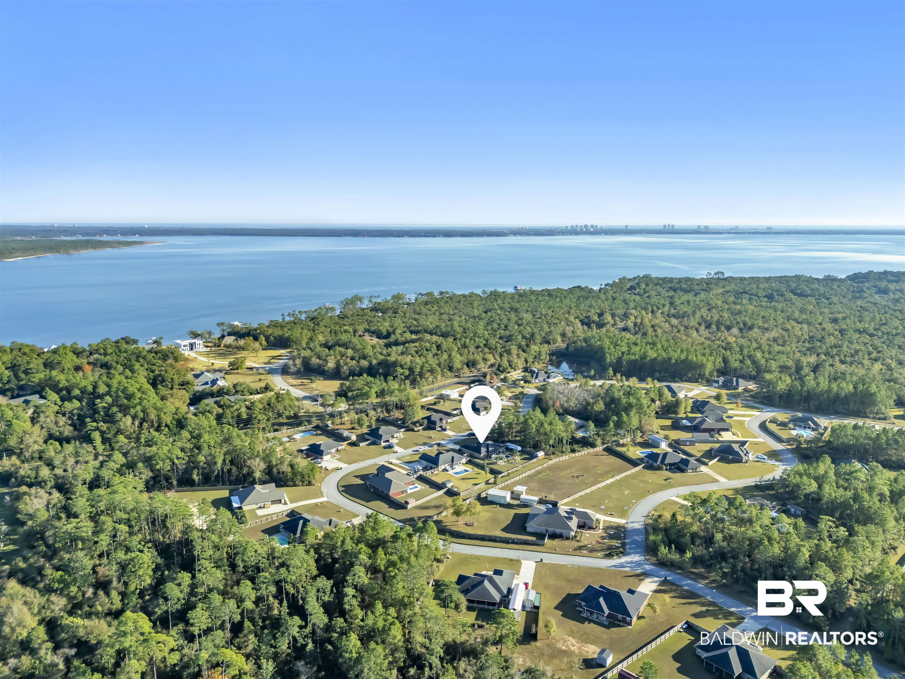 10180 Lyttleton Loop Lillian, AL 36549 - Photo 5 of 37 Aerial view of property's location featuring a heavily wooded area and a nearby body of water