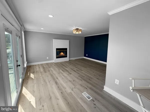 a view of an empty room with a fireplace