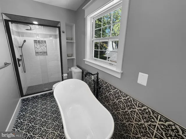 a bathroom with a bathtub and a toilet