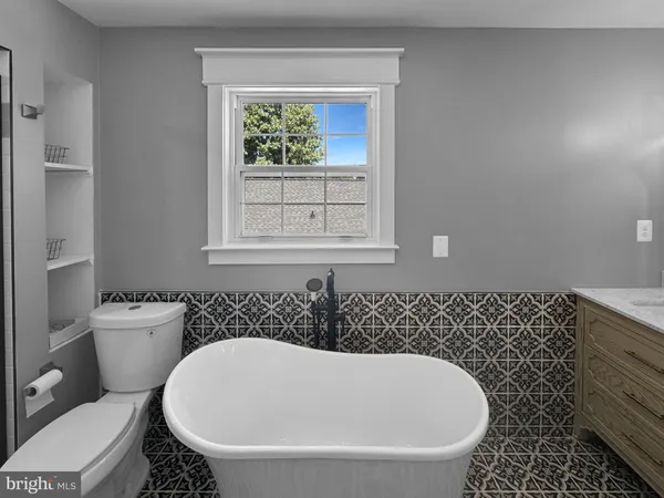 a white bath tub sitting next to a white toilet