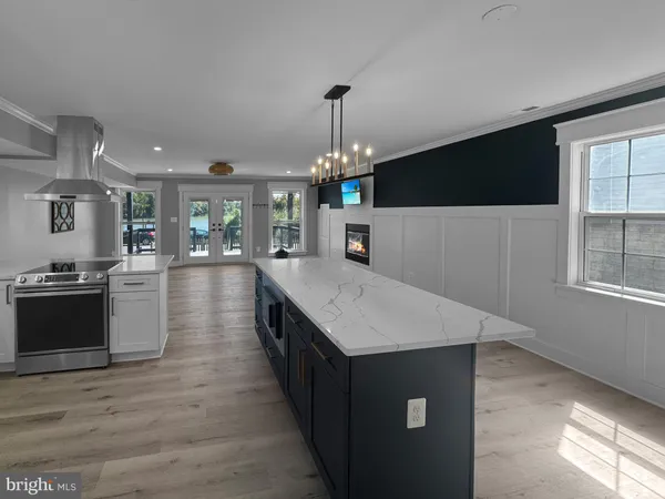 a kitchen with a stove a refrigerator and a kitchen island