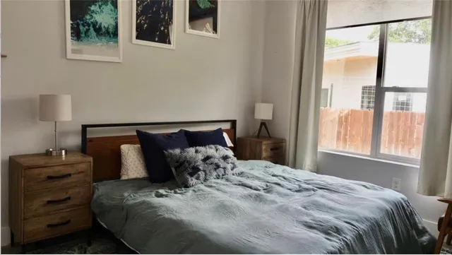 a bed sitting in a bedroom next to a window