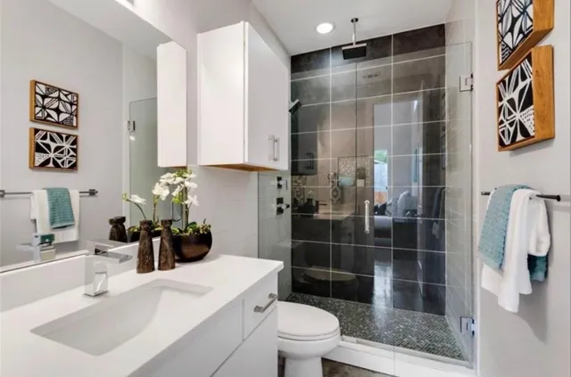 a bathroom with a sink toilet and shower