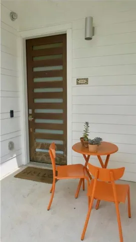 a view of a room with table and chairs