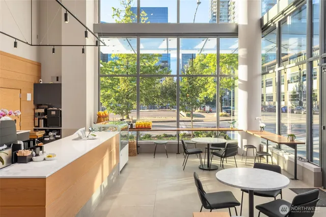 a kitchen with kitchen island a large window in it