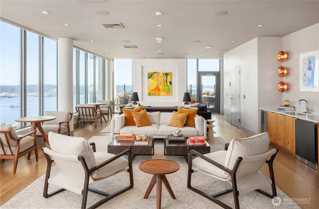 a living room with fireplace furniture and a large window
