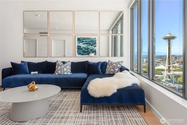 a living room with furniture and a floor to ceiling window