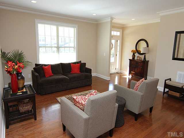12924 Edsel Drive Raleigh, NC 27613 - Photo 2 of 25 Gorgeous large living room greets you as you enter this beautiful home!, Features include hardwood floors, nine foot smooth ceilings, beautiuful crown molding. A light & bright open area!