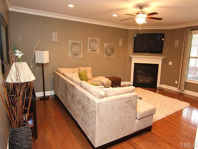 12924 Edsel Drive Raleigh, NC 27613 - Photo 8 of 25 Another great view of the family room, showing off the hardwood floors, crown moldings, ceiling fan, fireplace and your view to the screened porch.