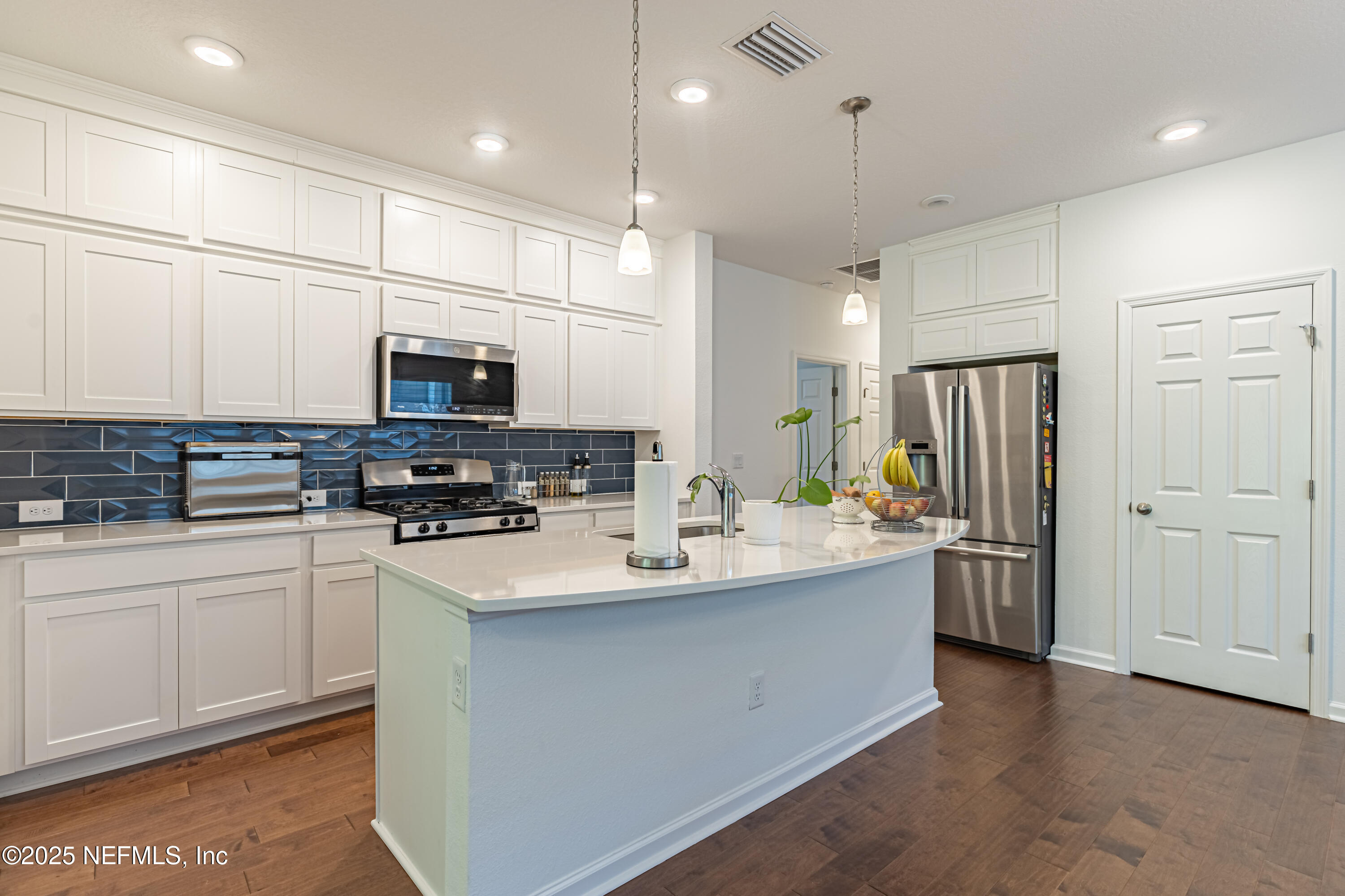 383 Windswept Way Street St. Augustine, FL 32092 - Photo 11 of 34 a kitchen with refrigerator and microwave