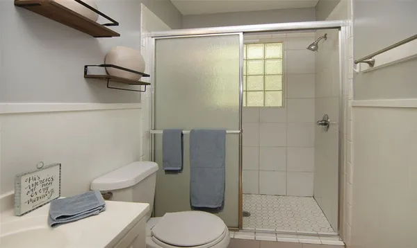 a white toilet sitting next to a bathroom sink