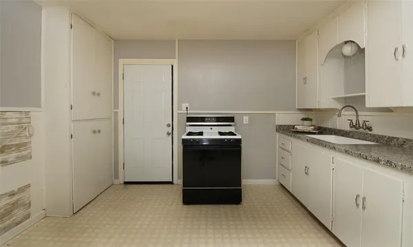 a kitchen with a sink and a stove top oven