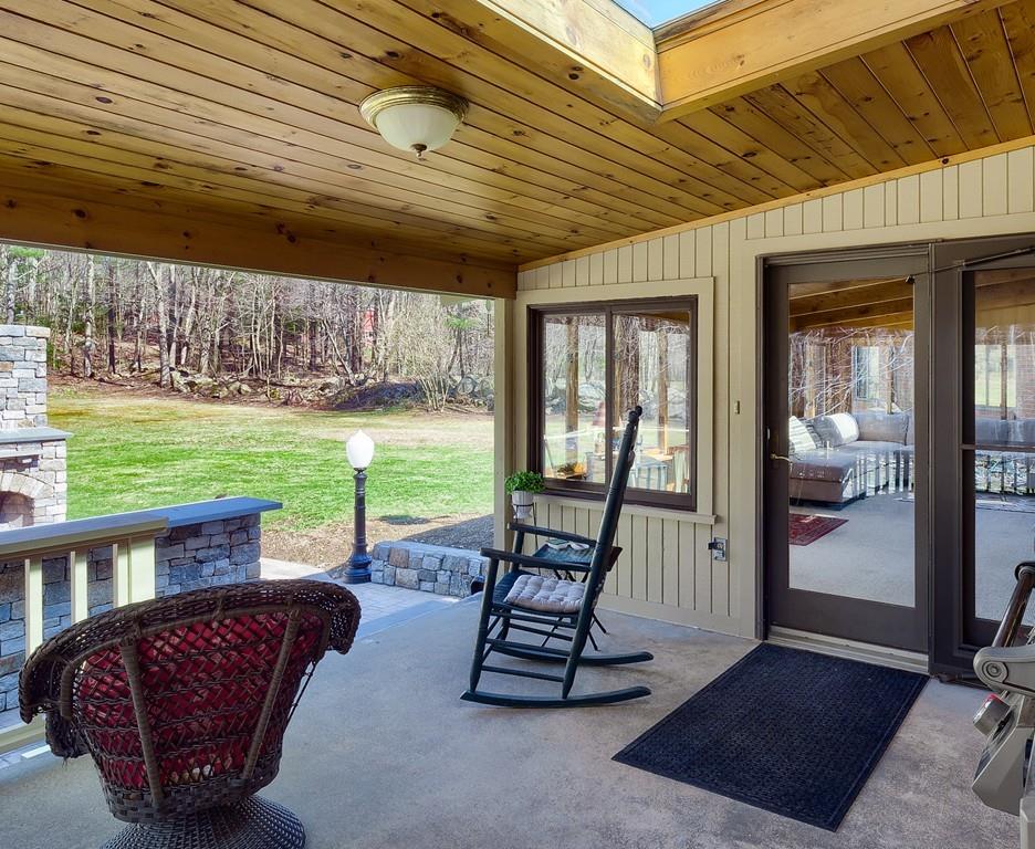 12 Lake Road Ashburnham, MA 01430 - Photo 34 of 38 a view of a patio with a dining table and chairs