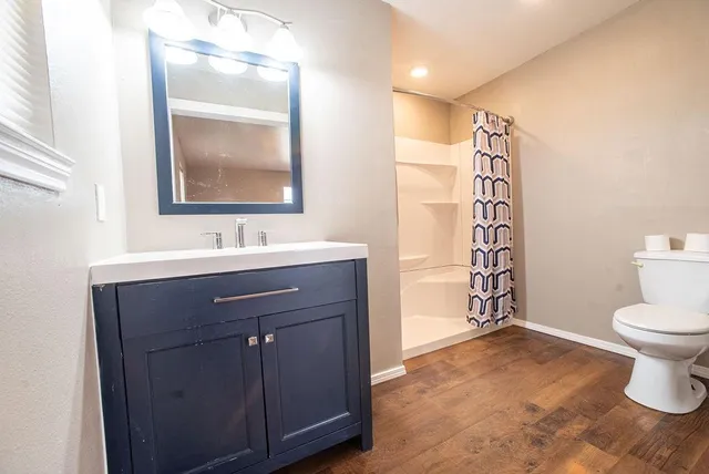 a bathroom with a sink toilet and shower